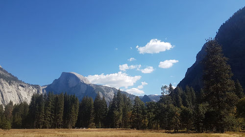 Panoramic view of snowcapped mountains against blue sky