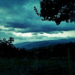 Scenic view of mountains against cloudy sky