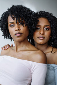 Portrait of two women of color hugging each other