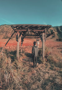 Full length of man standing on field against sky