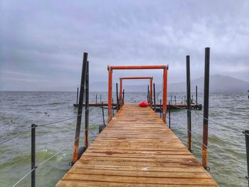 Pier over sea against sky