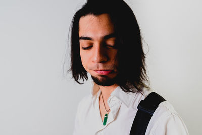 Portrait of young man against white background