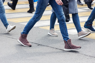 Low section of people walking on road