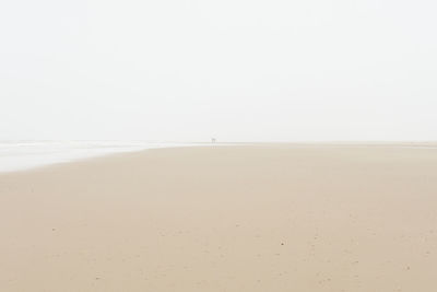 Scenic view of beach against clear sky