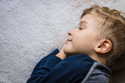 Close-up of boy sleeping on bed