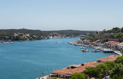 High angle view of town by sea against clear sky