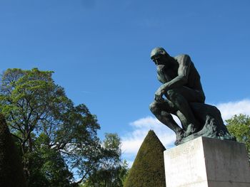 Low angle view of statue against blue sky