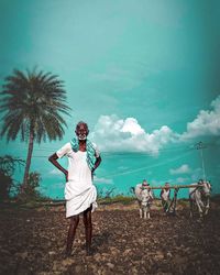 Men with umbrella on land against sky