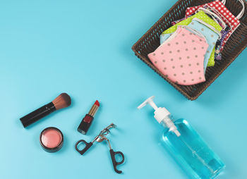 High angle view of objects on table against blue background