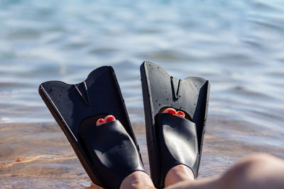 Low section of woman standing in water