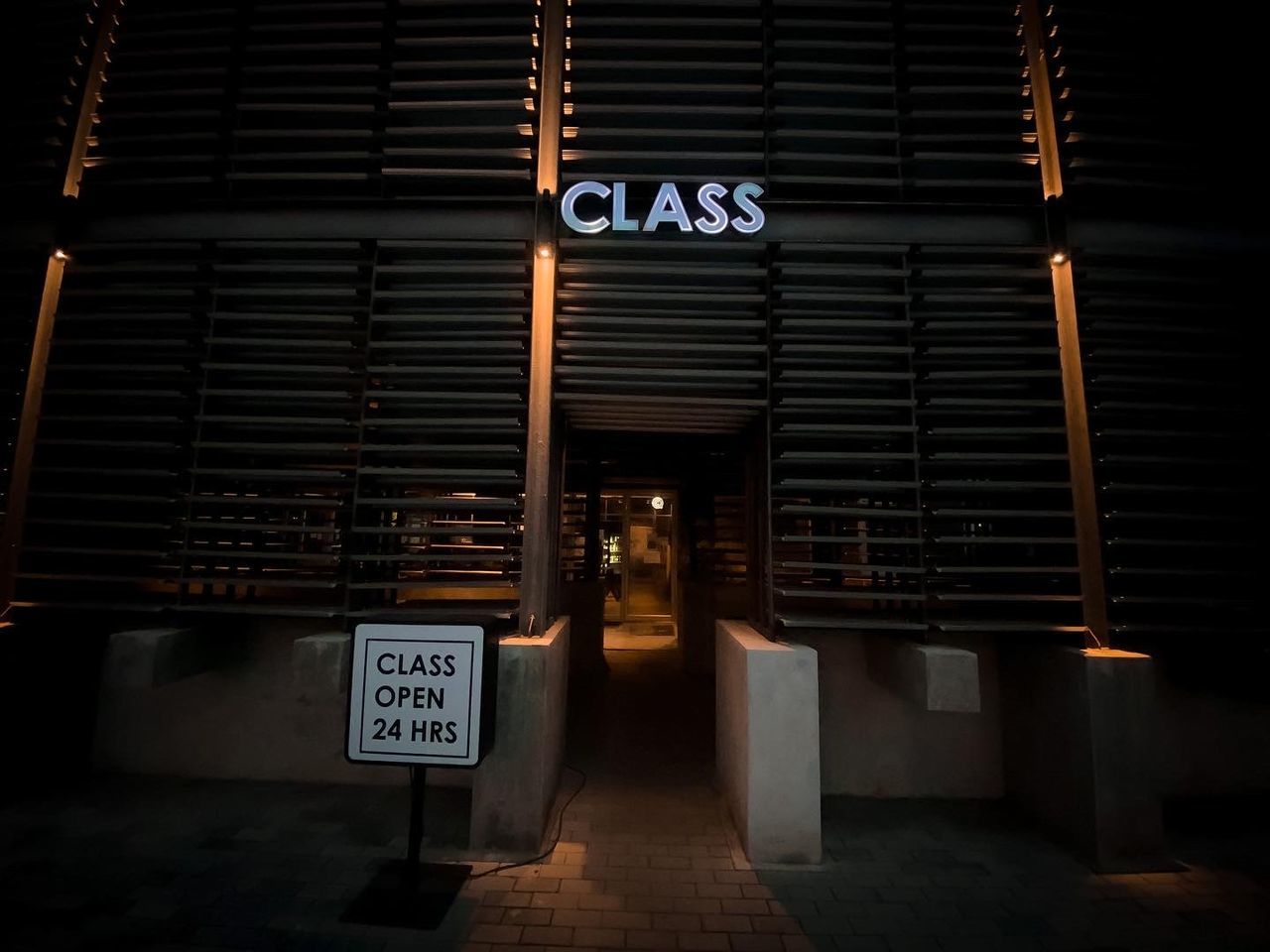 INFORMATION SIGN AGAINST ILLUMINATED BUILDING