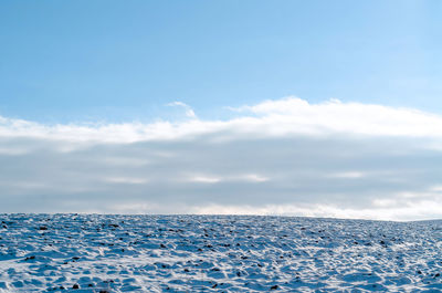 Winter snowy field under blue sky. seasonal concept.