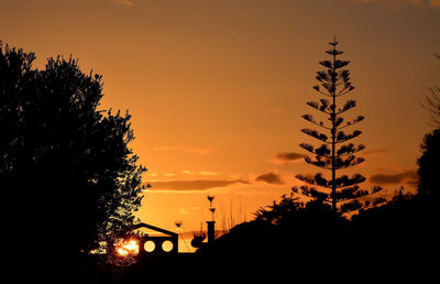 Silhouette trees against sky during sunset