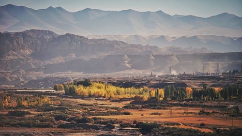 Scenic view of landscape and mountains against sky