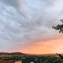 Buildings in city against sky at sunset