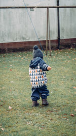 Rear view of boy walking outdoors