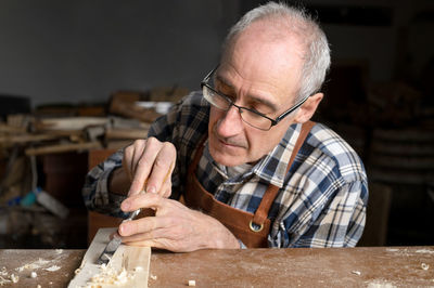 Close-up of man working at workshop