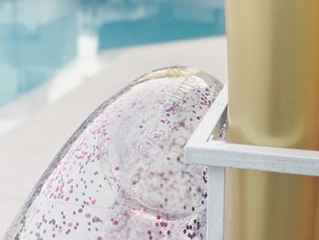 Close-up of girl with pink umbrella