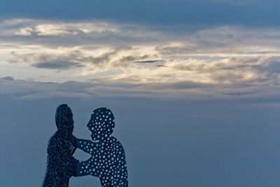 Silhouette of person against sky during winter