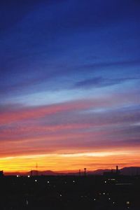 Silhouette of city at sunset