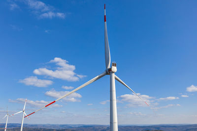 Low angle view of wind turbine against sky