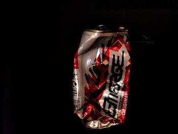 Close-up of illuminated lighting equipment against black background