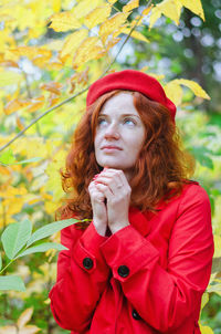 Young happy woman with red hair, freckles, blue eyes in beret in autumn park, smiling. lifestyle