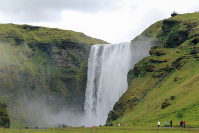 Scenic view of waterfall against sky