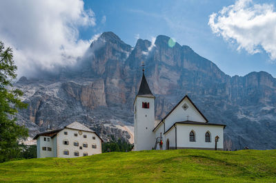 Scenic view of building and mountains against sky