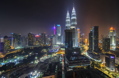 High angle view of city lit up at night