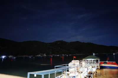 Scenic view of lake against sky at night