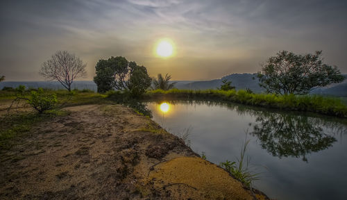 Scenic view of lake against sky during sunset