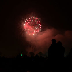 Low angle view of firework display at night