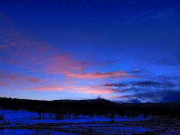 Scenic view of landscape against sky at night