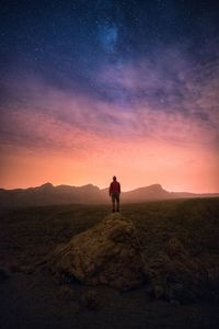 Silhouette man standing on mountain against sky during sunset