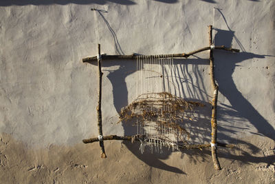 Close-up of fishing net against wall