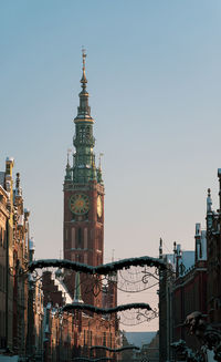 Buildings in city against clear sky