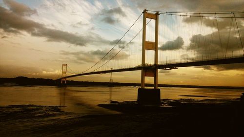 Bridge over sea at sunset