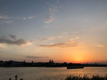 Scenic view of river against sky during sunset