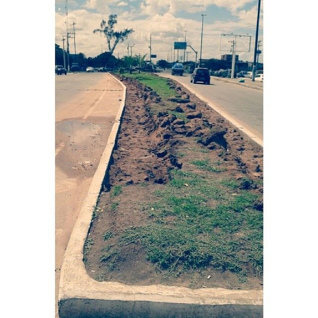 transfer print, auto post production filter, sky, transportation, the way forward, street, road, building exterior, cloud - sky, built structure, architecture, day, outdoors, sunlight, no people, diminishing perspective, cloud, road marking, tree, asphalt