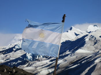 Argentinian flag against snow covered mountains