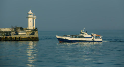 Ship sailing in sea against sky