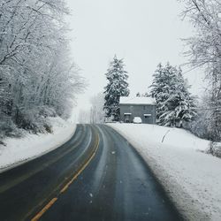 Road passing through snow covered landscape
