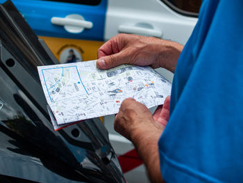 Cropped hands of man holding map