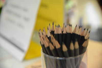 Close-up of pencils in desk organizer on table