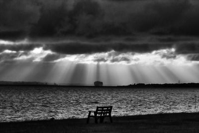 Scenic view of sea against storm clouds