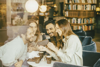 Young couple sitting on table at home