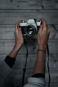 Midsection of woman photographing camera