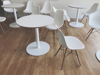 Empty chairs and tables on hardwood floor