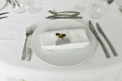 Table setting with cutlery and white napkin